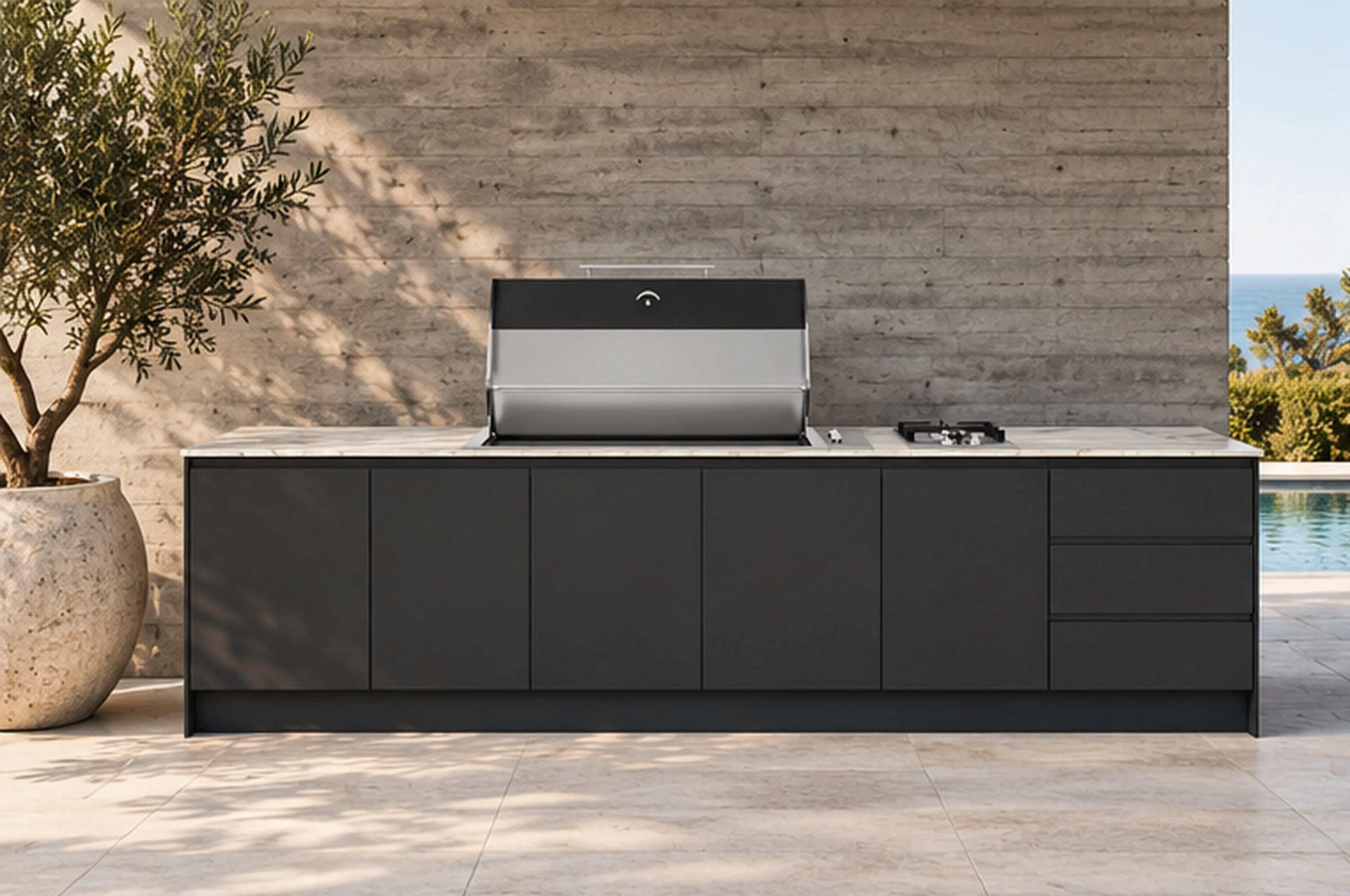 A charcoal outdoor kitchen with a light stone-look benchtop, integrated barbecue and side burner against a light concrete wall.