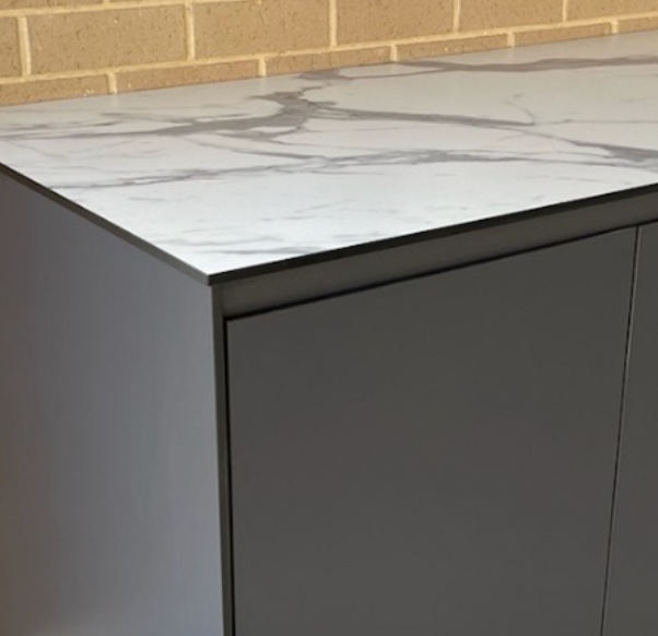 Outdoor kitchen cabinet run with an open appliance bay.